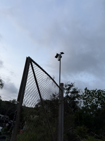 Camera pole mounted at perimeter fence line